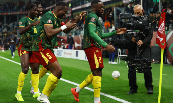 Cameroon players celebrate winning goal