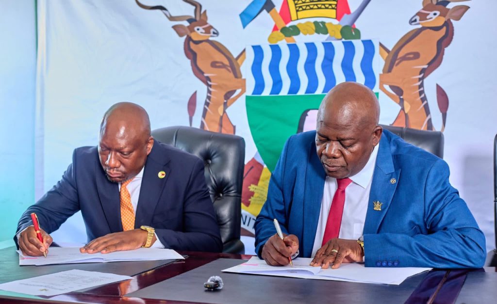 Betterbrands CEO Tonderai Sakupwanya and Minister of Primary and Secondary Education Torerayi Moyo sign a memorandum of understanding for the National Association of School Heads (NASH) tournament.