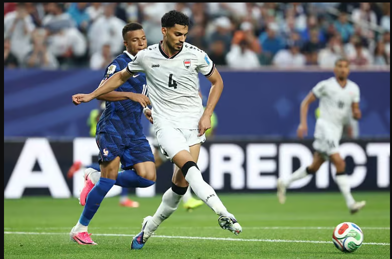 Iraq’s centre-back Zaid Tahseen clears the ball away from Kylian Mbappé.