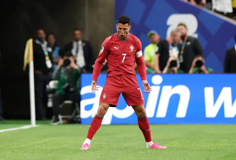 Cristiano Ronaldo of Portugal celebrates scoring his first of two World Cup goals against Uzbekistan. He becomes the first player to score in six World Cups.