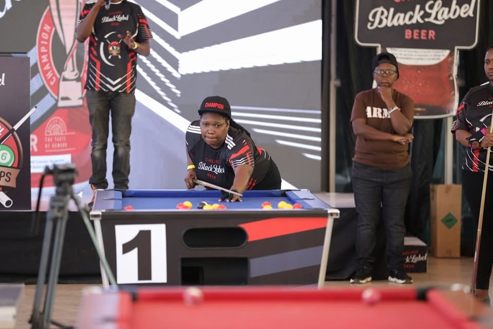 A woman prepares to hit a ball during the Carling Black Label Tournament in Zimbabwe.